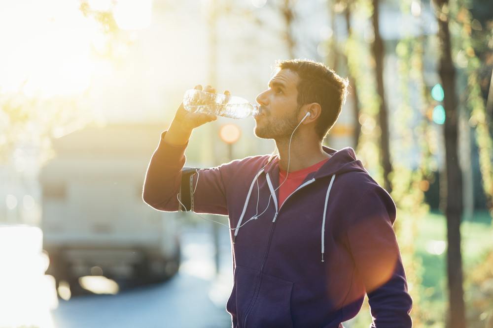 runner drinking mineral water at Strengthen the immune system